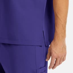 A close-up of a purple men's v-neck top featuring a side split and a hand holding it. The fabric appears smooth.
