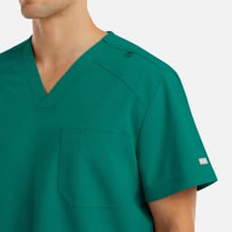A V-neck top in teal featuring short sleeves, a pocket, and a branding logo.