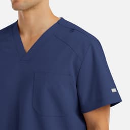 A navy blue V-neck top with a pocket, featuring a logo on the sleeve and shoulder snaps.