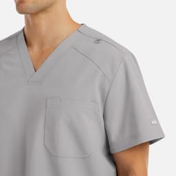 A grey men's v-neck top with a pocket, featuring a logo on the shoulder.