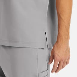 A grey men's tuckable V-neck top with side slits, featuring a close-up of the hem and sleeve.