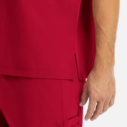 A close-up of a red men's tuckable V-neck top, highlighting the fabric and a seam detail.