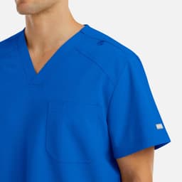 A men's v-neck top in a vibrant royal blue, featuring a chest pocket and branding on the sleeve.