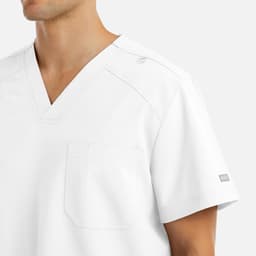 A white V-neck top with tuckable design, featuring a chest pocket and a logo on the sleeve.