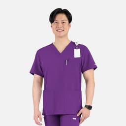 A purple men's V-neck top with four pockets, featuring a logo and worn by a smiling model.