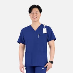 A V-neck top in navy blue with four pockets, featuring a logo and a badge attachment.