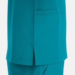 A teal V-neck top featuring four pockets and side slits for added comfort.