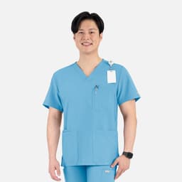 A men's v-neck top in light blue, featuring four pockets and a logo.