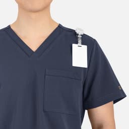 A navy V-neck top for men featuring contrast piping and a shoulder attachment for a name badge.