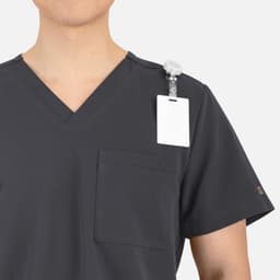 A men's grey V-neck top featuring contrast piping and a shoulder badge holder.