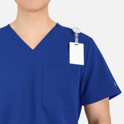A blue V-neck top featuring contrast piping, a pocket, and a clip-on badge holder.