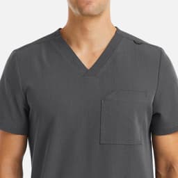 A grey V-neck top with short sleeves, featuring a front pocket and a logo on the shoulder.