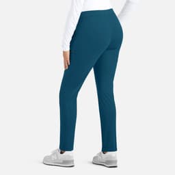 A pair of women's mid-rise tapered pants in teal, viewed from the back, featuring a logo on the waistband.