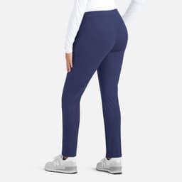A mid-rise tapered pant in navy blue, featuring a fitted design and a rear view. The model is wearing grey shoes.