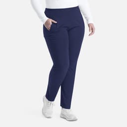 A pair of navy mid-rise tapered pants featuring a snug fit and side pockets, modelled by a person in white attire.