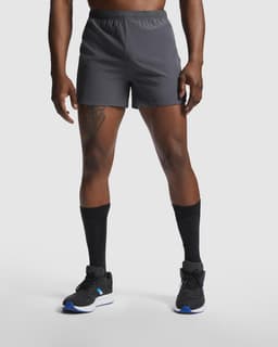 Sporty grey running shorts with an elastic waistband and branding, paired with black socks and footwear.