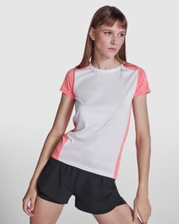 A women's T-shirt featuring a white body with coral accents, paired with black shorts. Includes a logo.