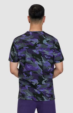 A camouflage t-shirt in shades of purple, black, and grey, featuring a round neckline and short sleeves.