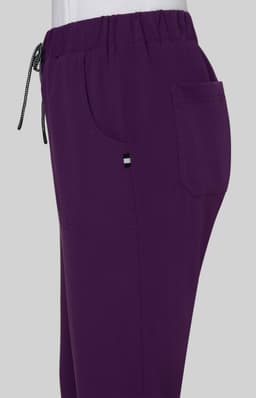 A pair of purple pants with an elastic waistband, featuring a pocket and a drawstring detail.