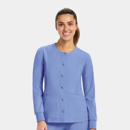 A women's round neck snap jacket in a light blue colour, featuring long sleeves and front pockets.