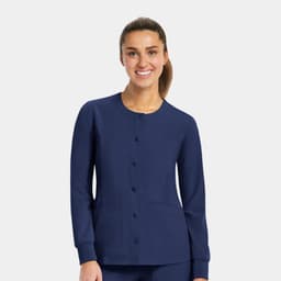 A women's round neck snap jacket in navy blue with long sleeves and front pockets, featuring a logo.
