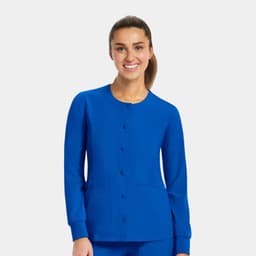 A blue women's round neck snap jacket with long sleeves and two front pockets, featuring a logo.