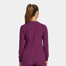 A women’s round neck snap jacket in a rich purple colour, featuring a simple design and long sleeves.