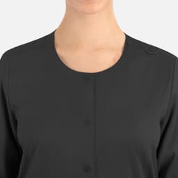 A women's round neck jacket in dark grey with a snap closure and a logo on the fabric.