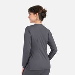A women's round neck snap jacket in dark grey, featuring long sleeves and a sleek, fitted design.