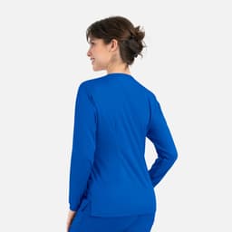 A women's round neck snap jacket in bright blue, featuring long sleeves and a sleek design. It has a small logo.