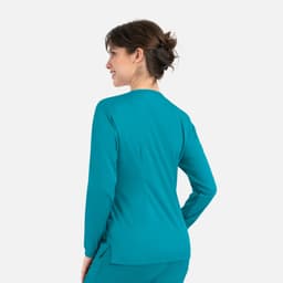A women's round neck snap jacket in a vibrant teal colour, featuring a fitted design and long sleeves.
