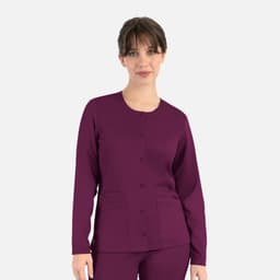 A rounded neck jacket in dark purple, featuring buttons and two front pockets. Model wears the jacket confidently.