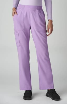 A pair of lavender boot cut pants features pockets and a fitted waistband, worn by a person in a white long-sleeve top.