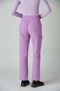 A pair of lavender boot cut pants featuring an elastic waistband and pockets, viewed from the back.