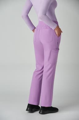 A pair of lilac boot cut pants with pockets, worn by a model from the back.