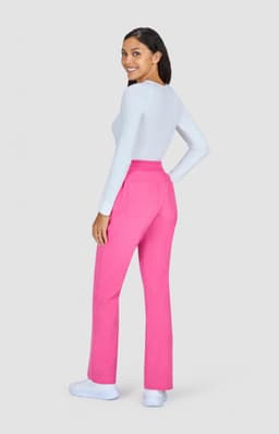 A pair of pink pants displayed on a model, featuring a back view and a white top. The image includes a logo.