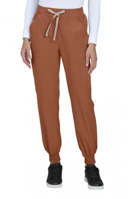 A pair of rust coloured joggers with side pockets, elastic cuffs, and a drawstring waistband, featuring a logo.