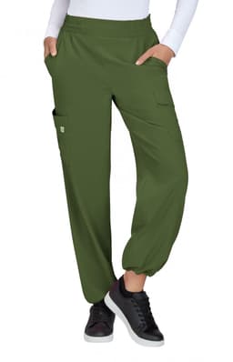 Olive green pants with an elastic waistband and pockets, styled in a relaxed fit. Footwear includes black sneakers.