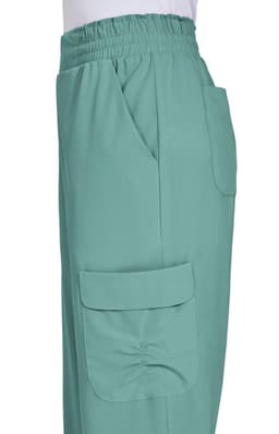 Ayla Pant in a soft green colour features an elastic waistband and side pockets. The product has a branding logo.