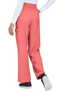 Coral-coloured pants with elastic waistband and pockets, viewed from the back with model wearing a white top.
