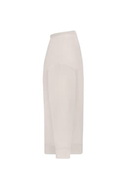 An oversized jumper in a light cream colour, featuring a side view with long sleeves and a ribbed hem.