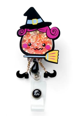 A colourful badge featuring a whimsical witch character with pink hair, a broom, and sparkling details, attached to a clip.