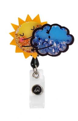 A vibrant sun and cloud shaker badge with glittery details, featuring yellow, blue, and clear elements, on a clear backing.