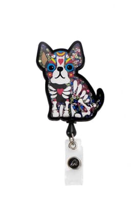A colourful dog-shaped badge with a patterned design, featuring sparkly embellishments and a clear attachment.