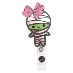A Koi Shaker Badge features a cute mummy character with a pink bow, sparkling accents, and a small logo.