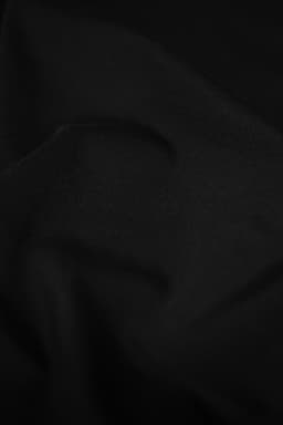A black fabric texture with subtle folds, showcasing the material of the Altavista Men Polo Shirt.