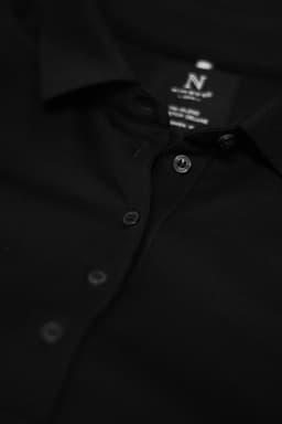 A black polo shirt with a collar and button placket, featuring a logo on the inside label.