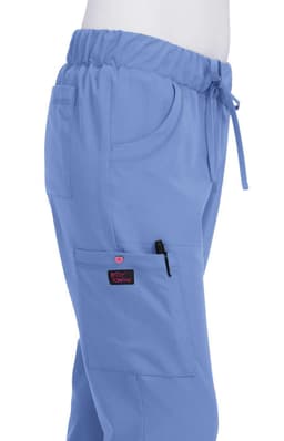 A pair of light blue pants with an elastic waistband and pockets, featuring a logo on the pocket.