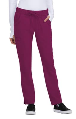 A pair of Buttercup Pant in a vibrant burgundy colour, featuring pockets and a drawstring waistband.