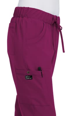A pair of fuchsia pink pants with an elastic waistband, featuring pockets and a logo patch.
